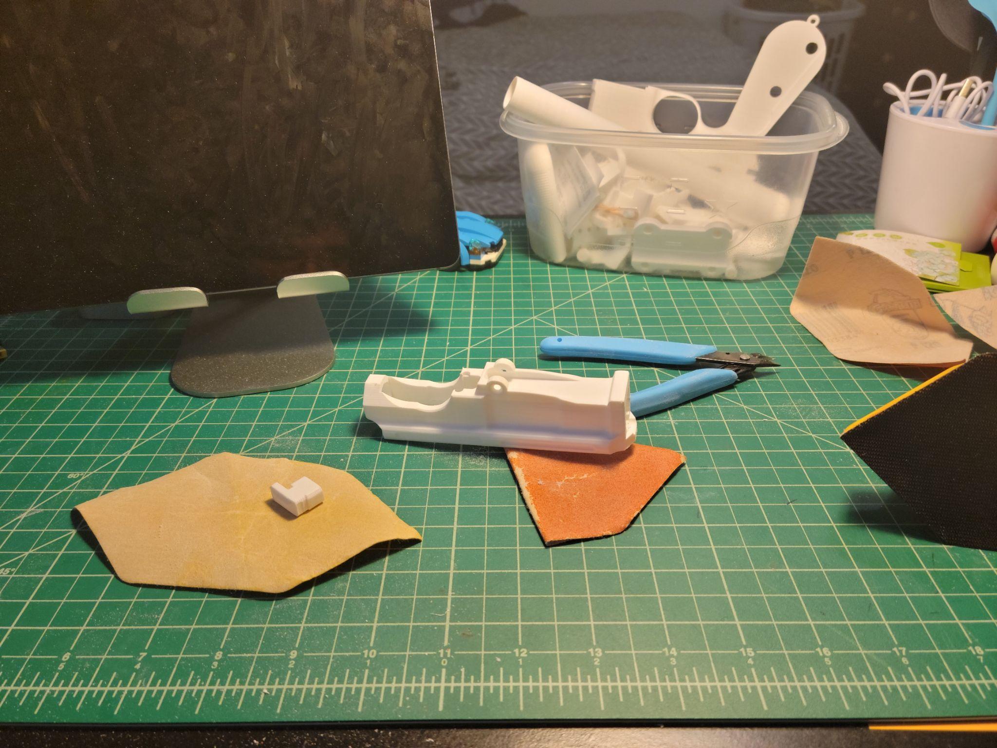 Sanding the printed parts — working through progressively finer grits